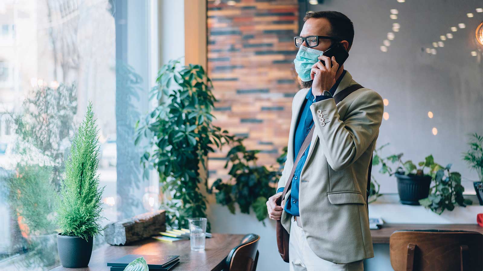 business-man-on-phone-with-mask-on
